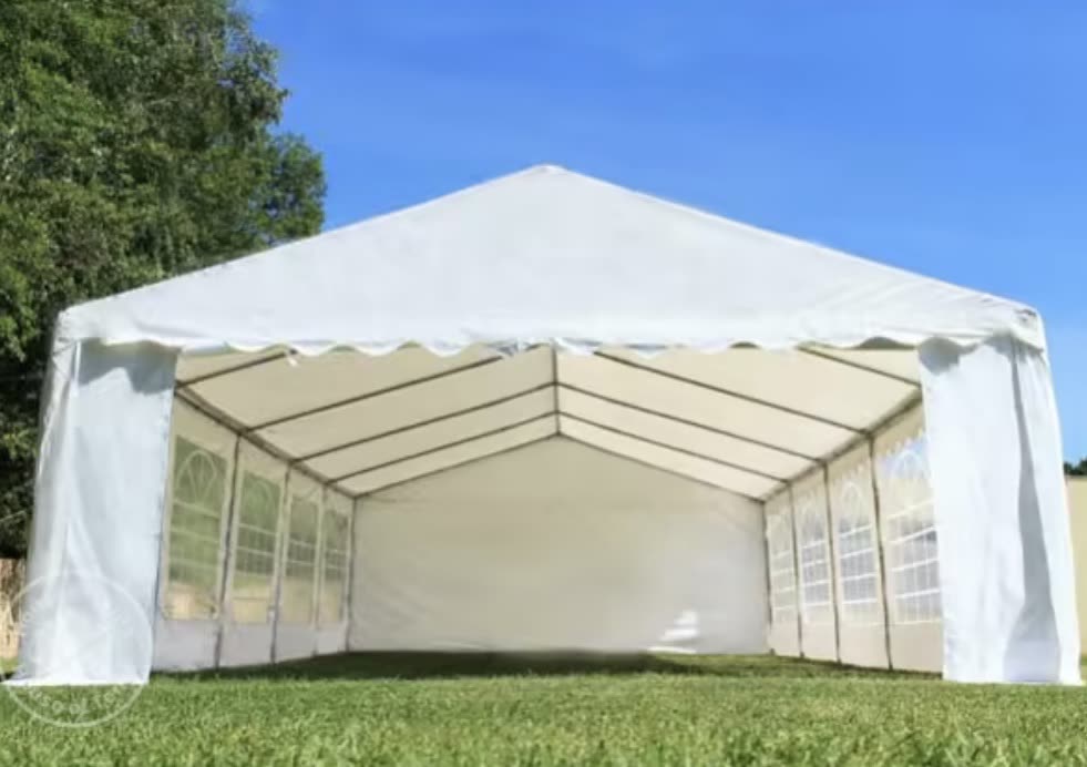 Large white marquee set up on a green lawn
